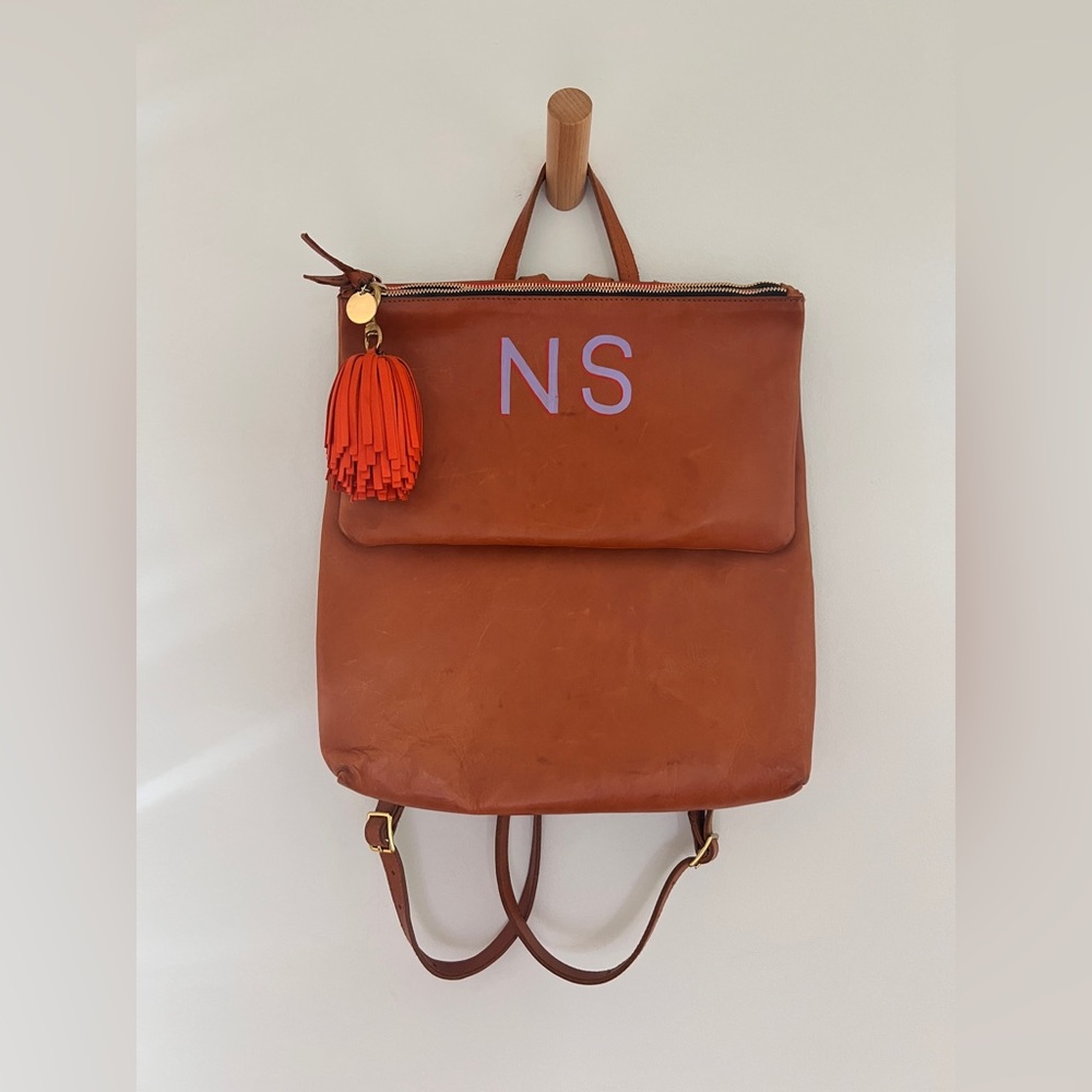 Clare V. Agnes Tan Backpack with painted monogram and Poppy Tassel